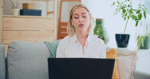 Woman Working on Laptop at Home