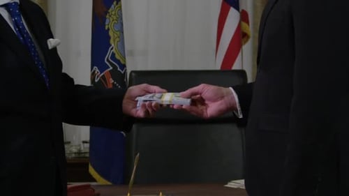 Money in politics - cash and handshake HD