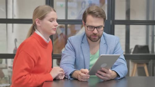 Business Colleagues Video Chat on Tablet at Office