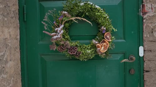 Christmas Wreath Hanging on Dark Green Door