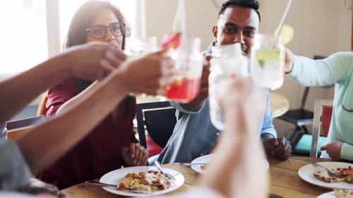 Leisure, Food And People Concept - Group Of Happy International Friends Eating And Clinking Glass...