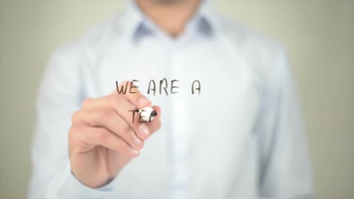 Man Writes 'We Are A Team' On Glass Surface
