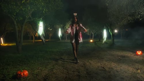 Zombie Woman Walks In The Halloween Forest Among The Pumpkins