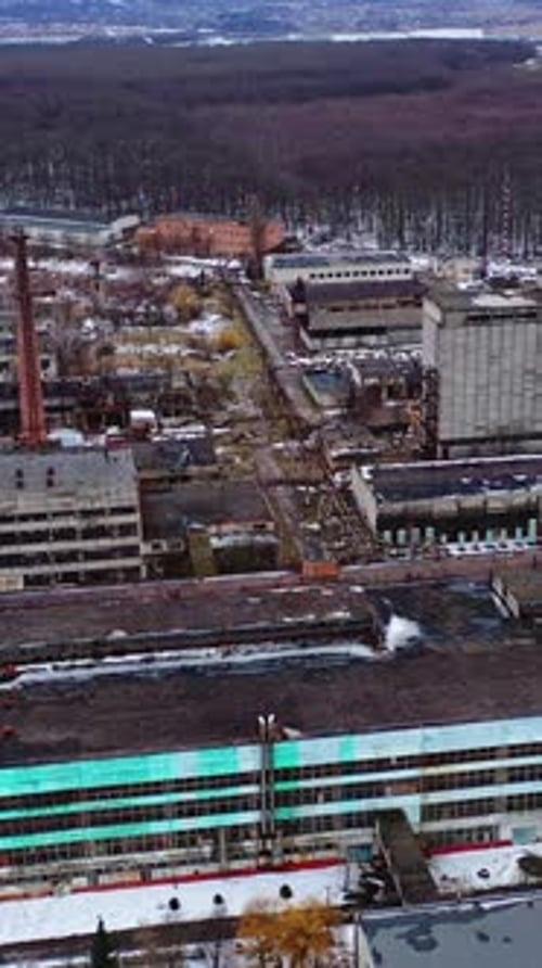 Empty broken industrial plant. Old factory near the forest.
