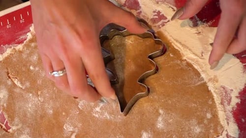 Close shot of a woman using a cookie cutter