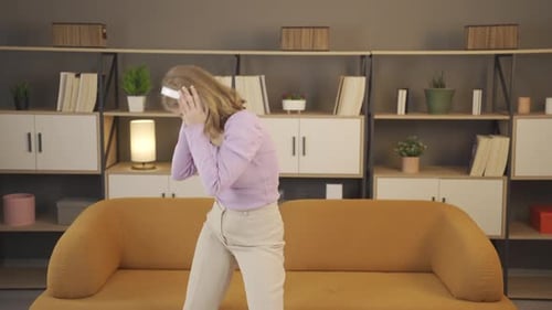 Woman Dancing with Headphones in Living Room