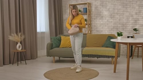 Woman Organizes Personal Items Inside Her Purse