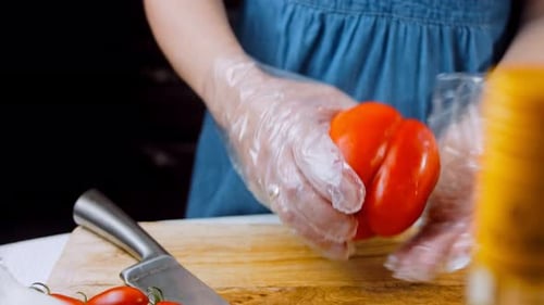 Front View of the Young Chef Cut Thin Slices of a Piece of Red Pepper with a Knife on the Cutting