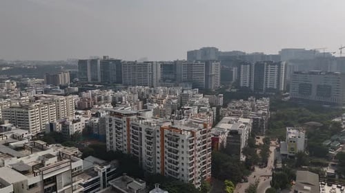 Overhead drone footage of an urban district with repeating building patterns and traffic flow,