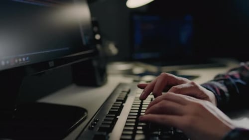 Programming and writing code, A girl is sitting at a table working on a laptop PC, The computer