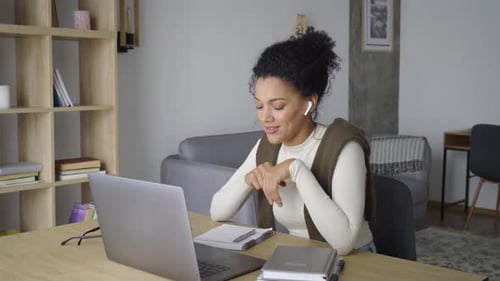 African American Mixed Race Adult Teacher Wearing Earphones Having Virtual Meeting Online