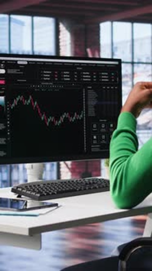 Young Adult Analyzing Financial Data in Modern Office