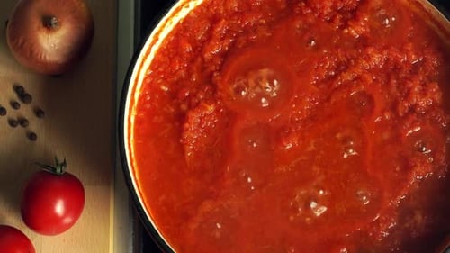 Close Up of of Boiling Tomato Italian Sauce for Pasta or Pizza Cook on Stove in Saucepan