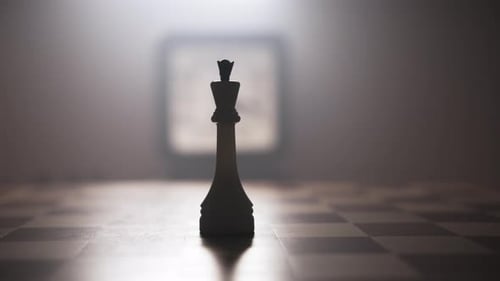 Man Hand Remove the Queen Piece From Center of Chessboard