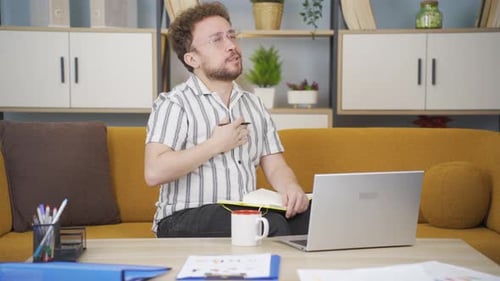Man tired from work yawns.