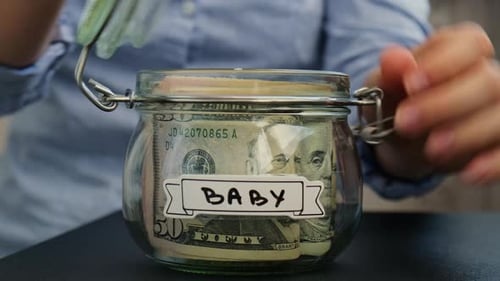 Saving Money for Baby in Glass Jar