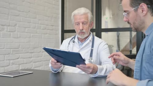 Doctor Discusses Medical Form with Patient