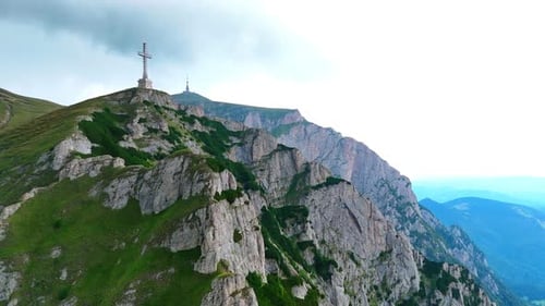 Cross monument on mountain ridge in Bucegi Mountains.