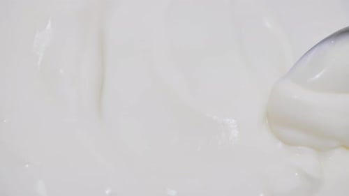 Shooting of Bowl with Stirred Yoghurt and Spoon
