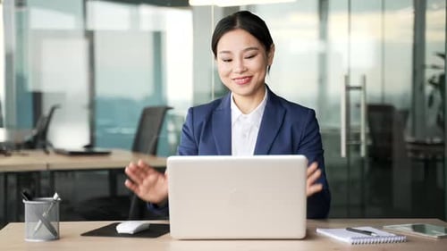 Professional Woman Working Happily on Laptop in Modern Office