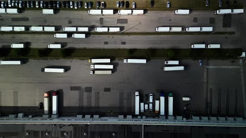 Aerial View of Parked Semi Trucks at a Logistics Hub Shows Efficient Transportation and Freight