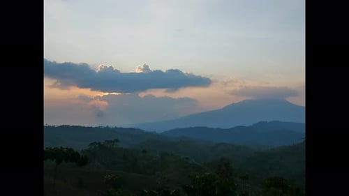 Sun Rises over Mountain Range at Dawn