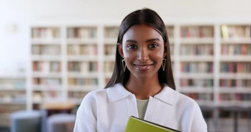 Books, education and library with face of woman on campus for research, studying or learning