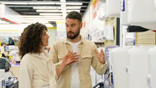 Couple Choosing Discounted Air Conditioner in Appliances Store