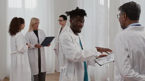 Team of Doctors Discussing Charts in a Hospital