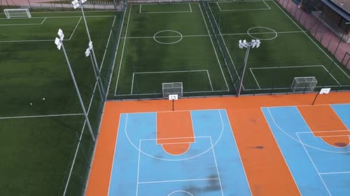 Aerial View of Outdoor Basketball and Soccer Courts with Vibrant Blue Orange and Green Colors The