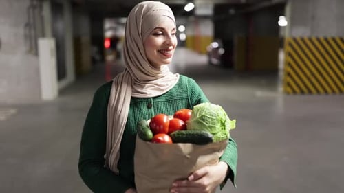 Woman with Groceries in Parking Garage