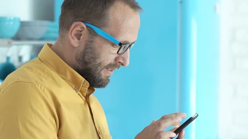 Man Using Smartphone in Modern Bright Home Interior