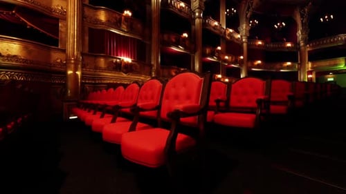 Empty Grand Theater Auditorium with Ornate Gold Decor and Red Seats