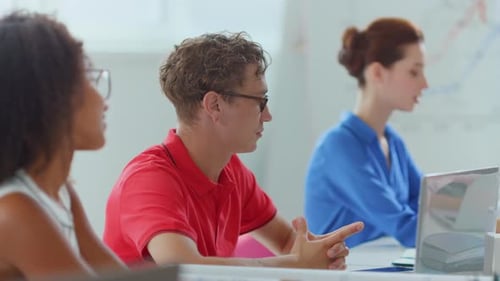 Team members attentively listening in meeting indoors
