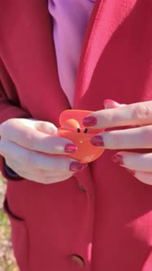 Hands Open Wireless Earbuds Case Showing Earbuds