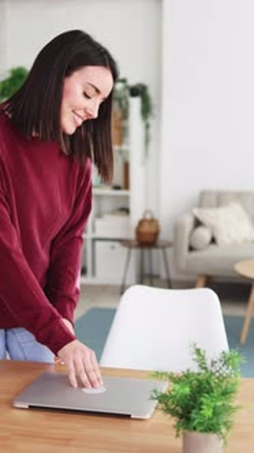 Woman Opens Laptop and Works from Home