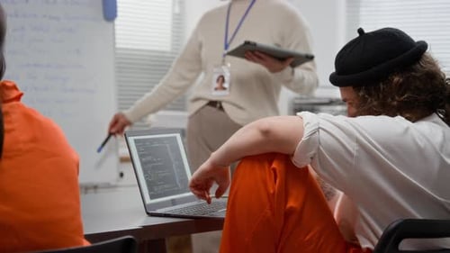Inmate Using Computer during Programming Class in Prison