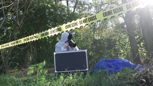 Person in Suit Taking Photos at Crime Scene