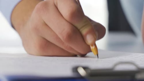 Hand Writing on Paper with Pencil Close Up