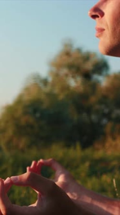 Man Meditating Outdoors in Golden Light