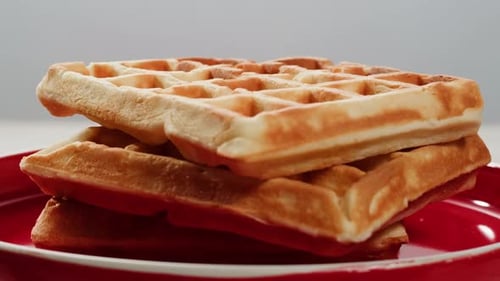 Golden Waffles Stacked on a Plate Close-Up