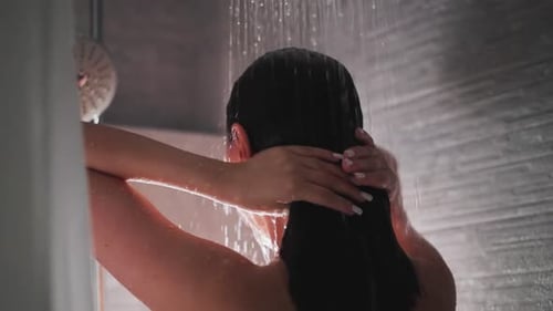Young Lady Using Modern Shower to Wash Hair