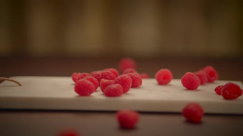 Fresh Red Raspberries on White Cutting Board