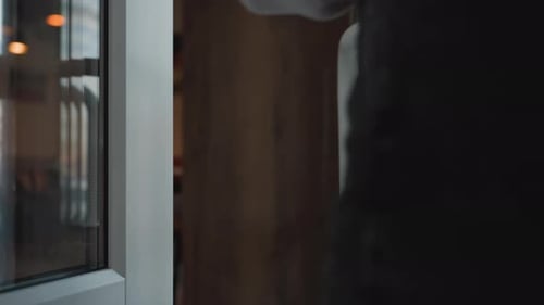 Hand of Lady in Sweater Opens Glass Door While Entering Mall