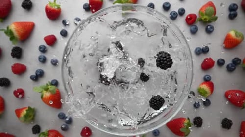 Blackberries Splashing in Water Surrounded by Berries