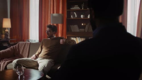 Man Talking While Sitting on Sofa Indoors