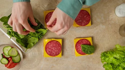 Making Salami Sandwiches with Spinach and Cheese