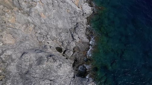 Rocky Coastline Meeting Turquoise Ocean From Above