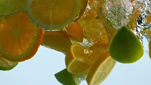 Slices Fresh Citrus Fruit Falling Into Water Close Up