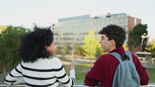 Cheerful young multiethnic students laughing together while having fun on the university campus